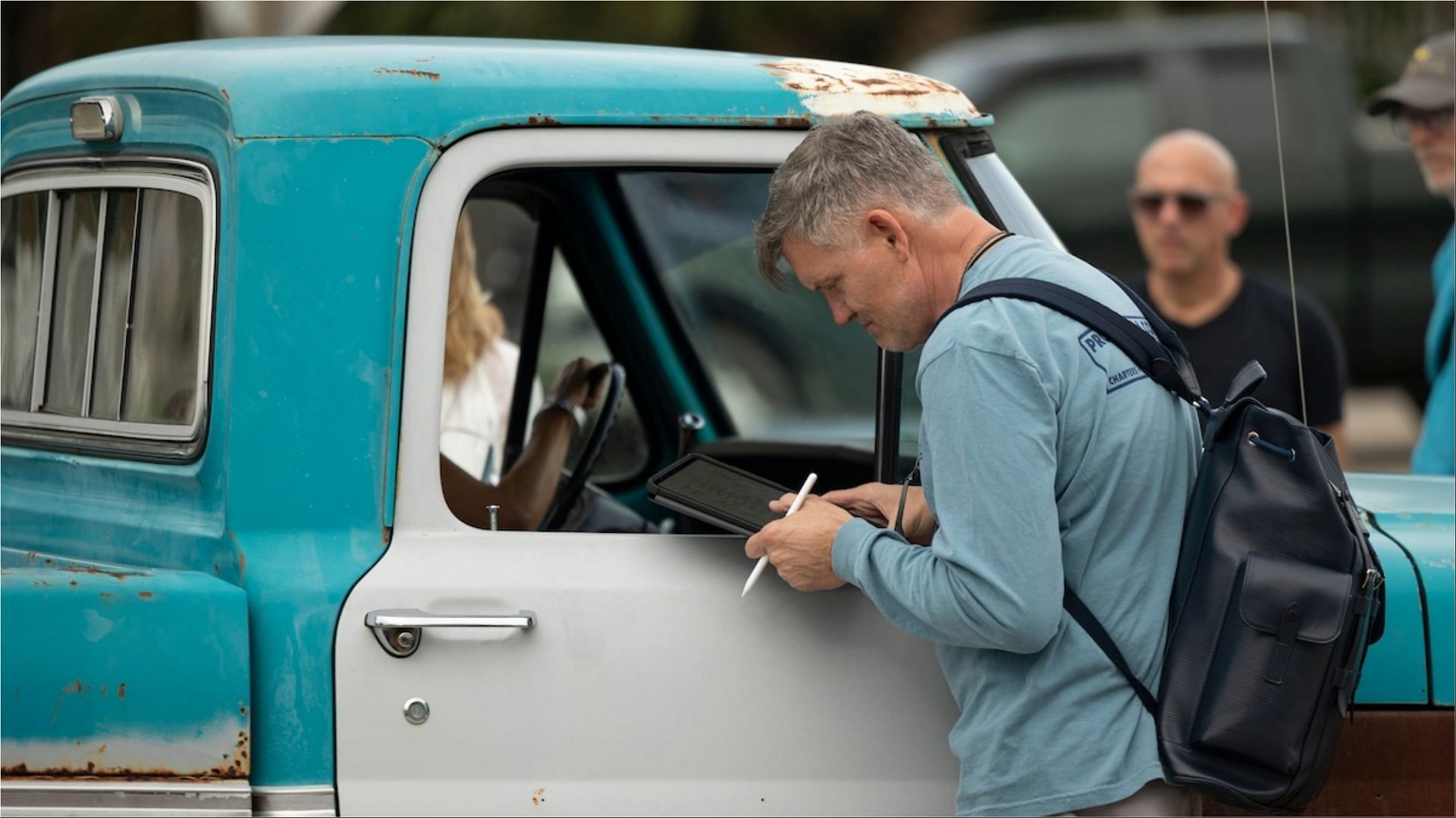 The Waterfront creator Kevin Williamson reviews notes on set during a filming day in coastal North Carolina. (Image via Netflix)